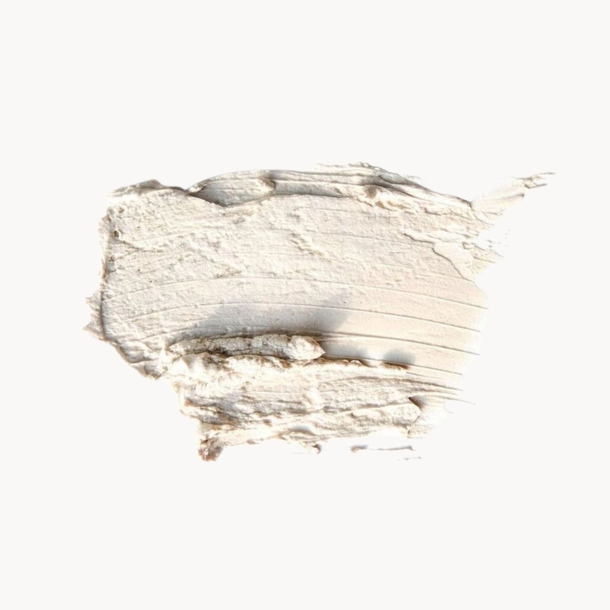 Close-up view of a textured face mask cream, showcasing its natural texture and colors.