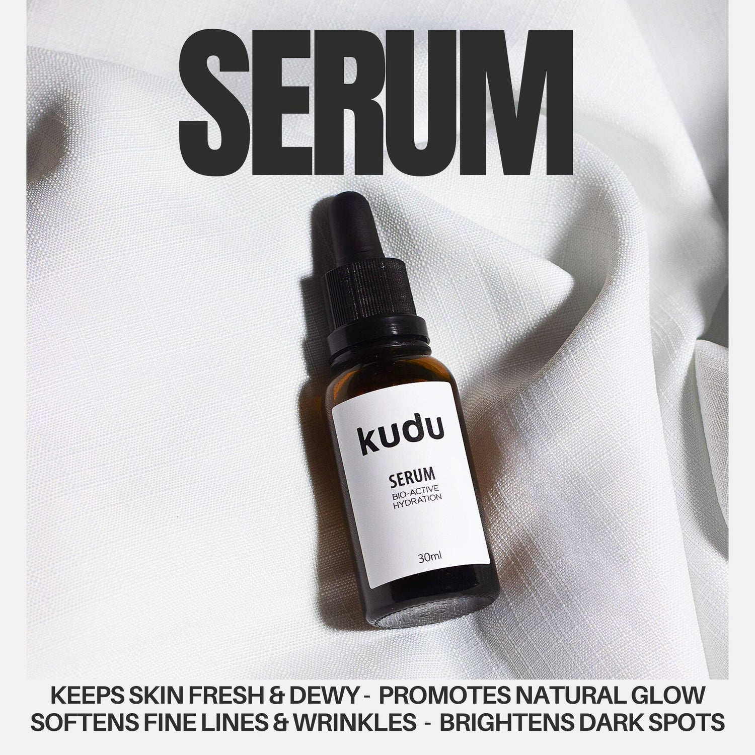 A dropper bottle labeled "Kudu Serum" on a white fabric background, promotes hydration, glow, wrinkle reduction, and brightening dark spots.