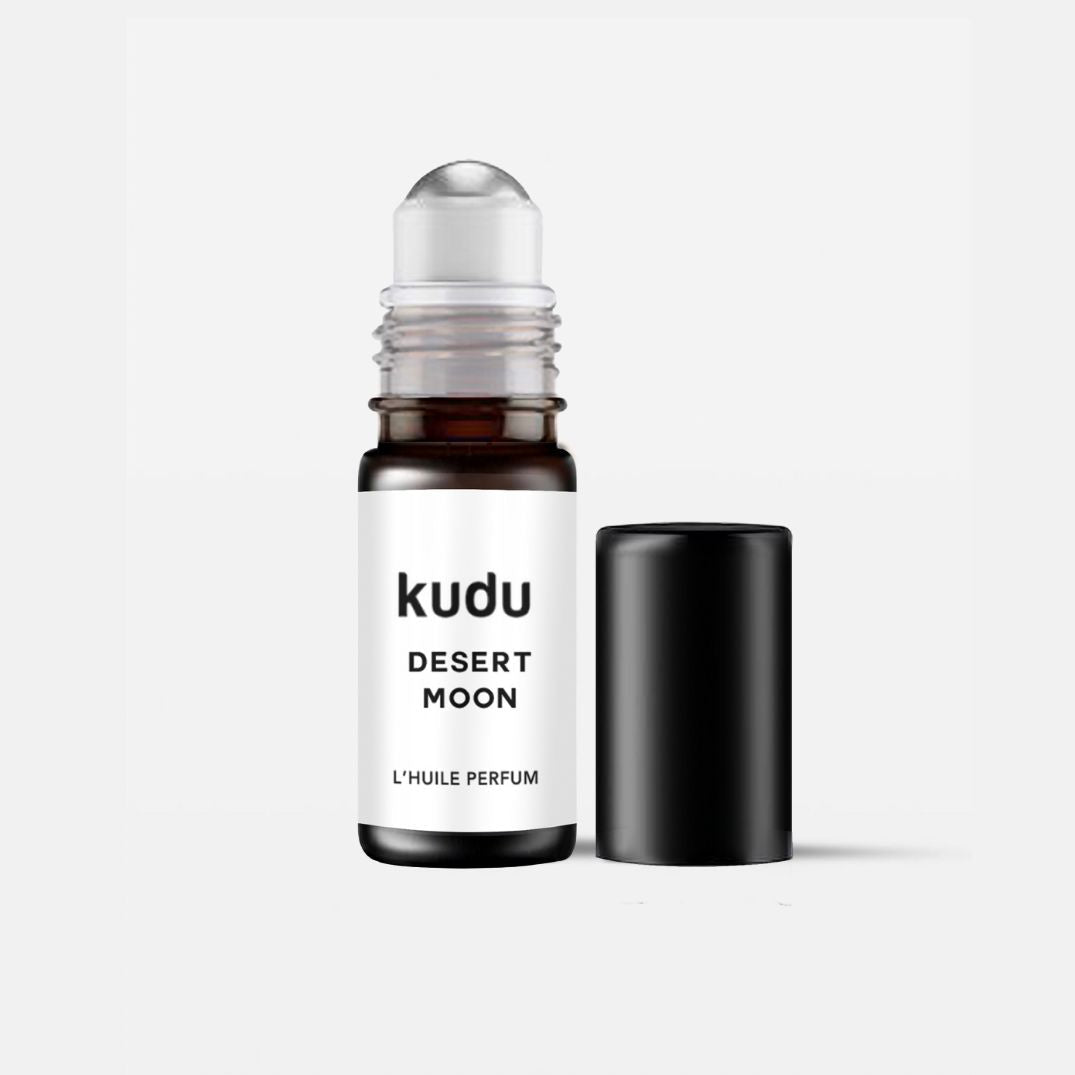 Roll-on perfume titled "Kudu Desert Moon." The clear bottle with a black cap is open, showcasing a sleek, minimalist design on a white background.