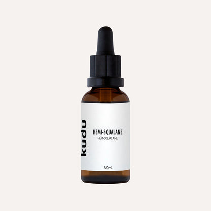 Aglass bottle of Kudu Cosmetica Hemi Squalane on a plain background