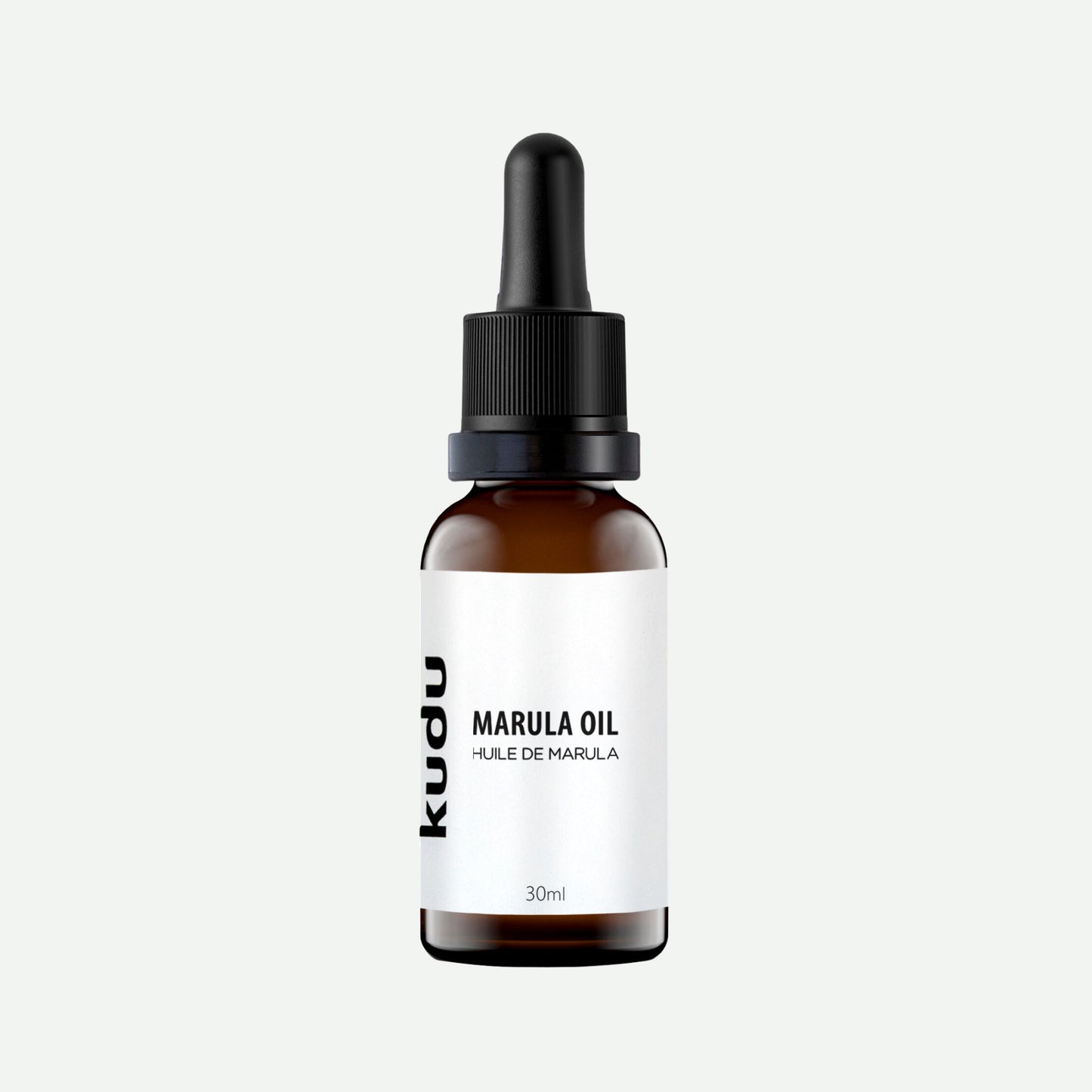 An amber dropper bottle of Kudu Cosmetica Marula Oil for Face on a plain background