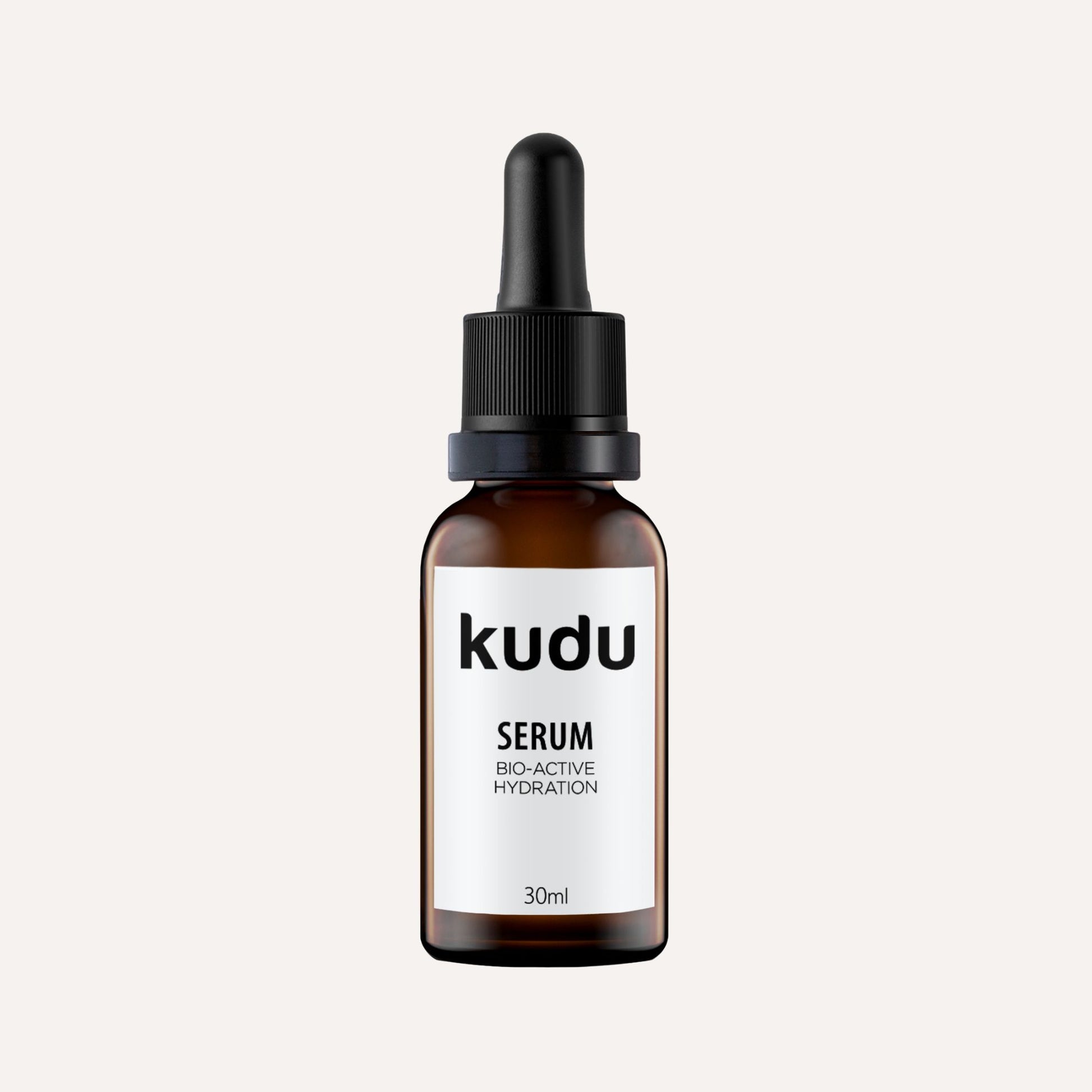 An amber glass bottle of Kudu Cosmetica Serum on a plain background