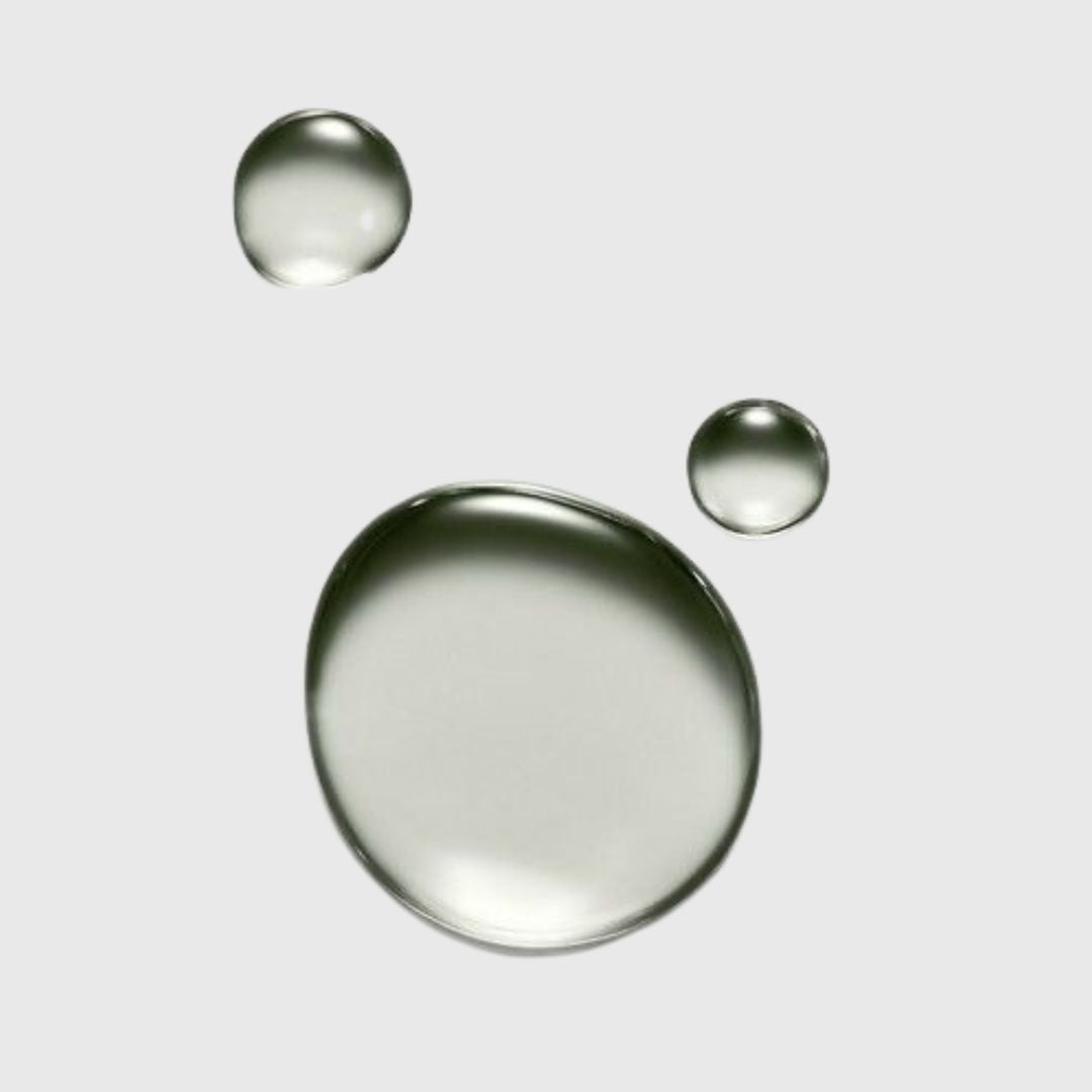 An image of droplets f squalane oil on a plain background.